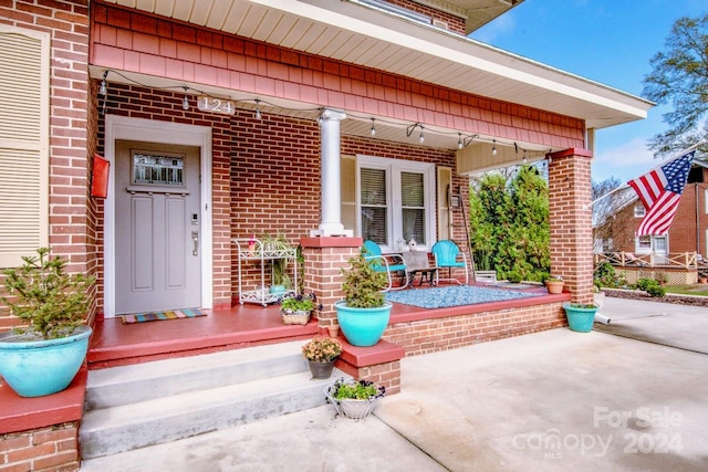 doorway to property featuring covered porch