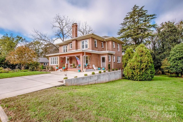 view of front of house with a front yard and a porch