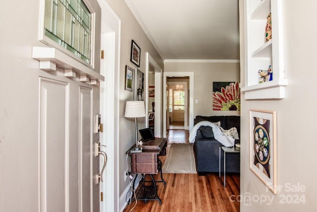 foyer entrance featuring hardwood / wood-style flooring and crown molding