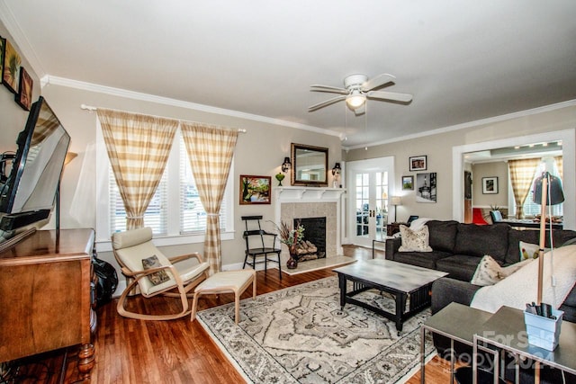 living room with ornamental molding, hardwood / wood-style flooring, and ceiling fan