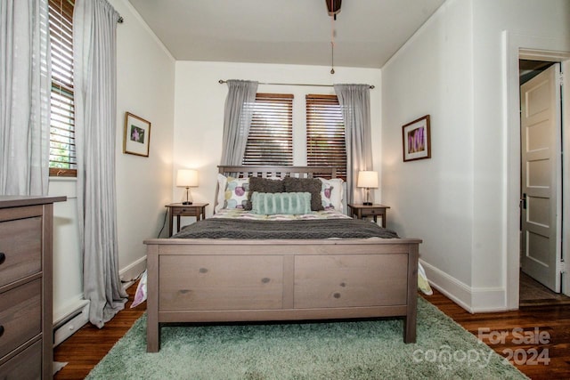 bedroom with dark hardwood / wood-style flooring