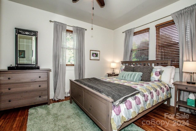 bedroom featuring ceiling fan and dark hardwood / wood-style flooring