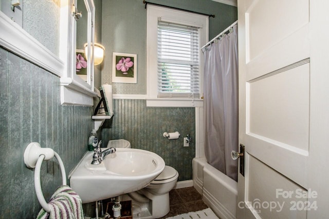 bathroom with toilet, shower / bath combo, and tile patterned floors