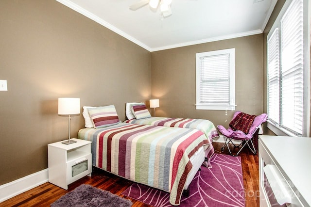 bedroom with ceiling fan, crown molding, and dark hardwood / wood-style flooring