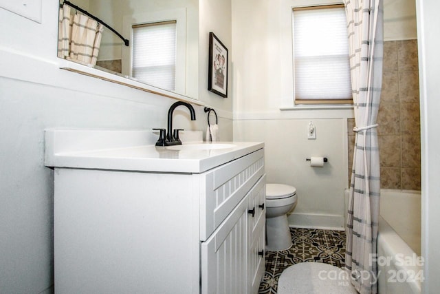 full bathroom featuring toilet, shower / tub combo, vanity, and tile patterned floors