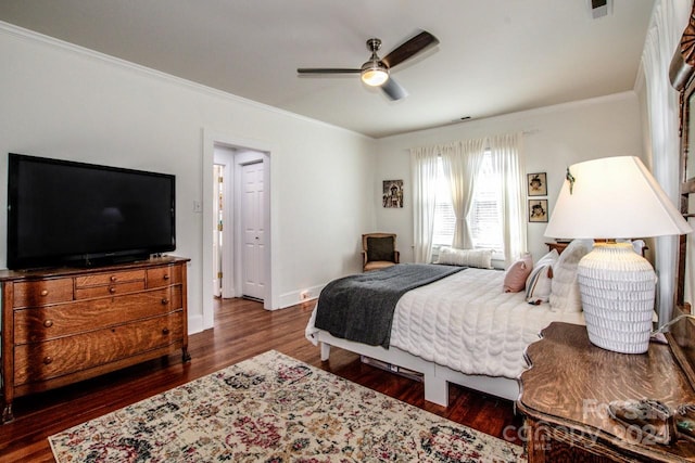 bedroom with ornamental molding, dark wood-type flooring, and ceiling fan