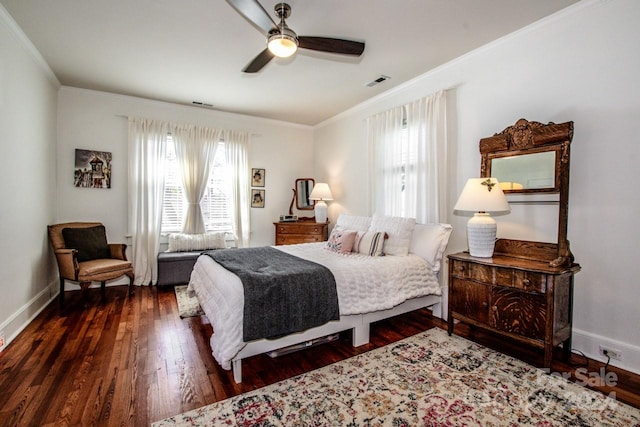 bedroom featuring dark hardwood / wood-style flooring, ceiling fan, and crown molding