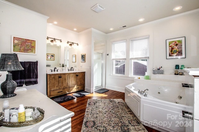 bathroom with independent shower and bath, vanity, hardwood / wood-style floors, and ornamental molding