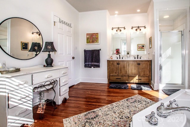 bathroom with wood-type flooring, crown molding, vanity, and a shower with shower door