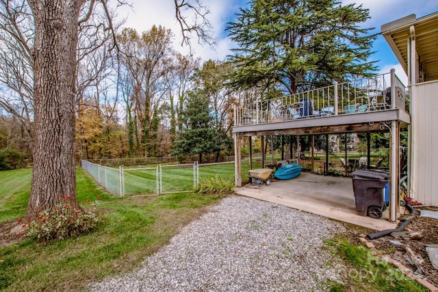 view of yard with a wooden deck and a patio