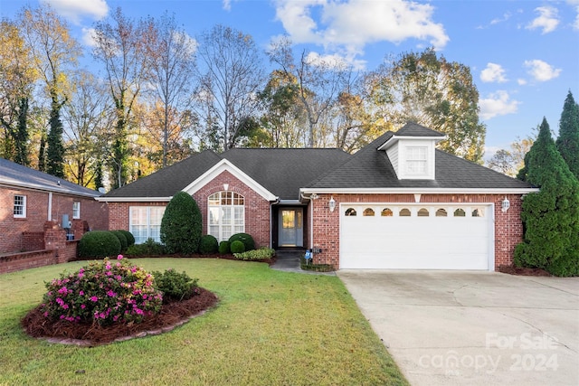 view of front of home featuring a garage and a front yard