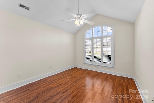 empty room with hardwood / wood-style floors, ceiling fan, and lofted ceiling