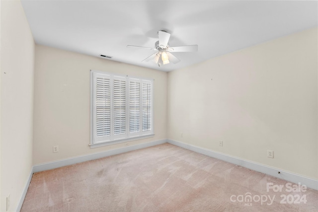 empty room featuring light carpet and ceiling fan