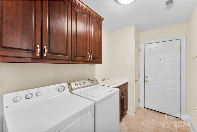 washroom with washer and clothes dryer, cabinets, sink, and light tile patterned floors