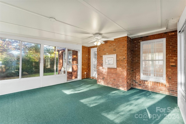 unfurnished sunroom with ceiling fan