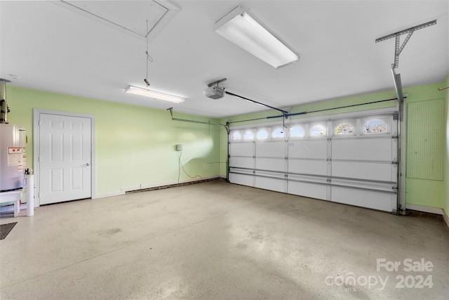 garage featuring water heater and a garage door opener