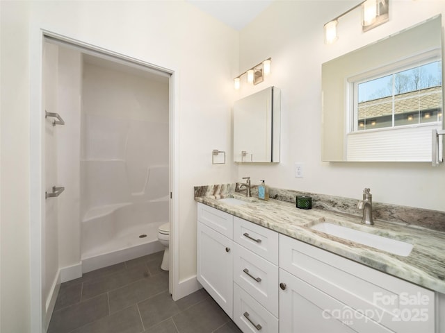 full bathroom with toilet, a sink, tile patterned floors, and a shower stall