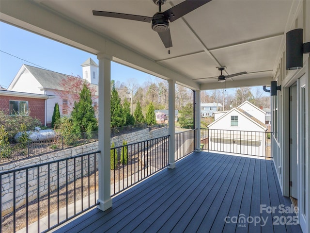 wooden terrace featuring fence and ceiling fan