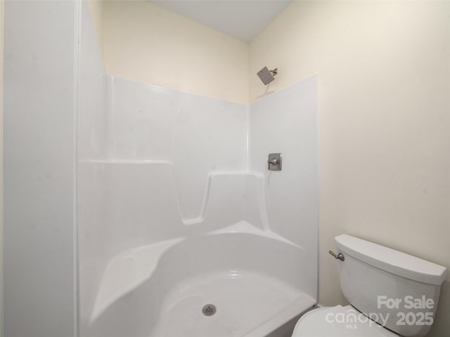 bathroom featuring toilet and walk in shower