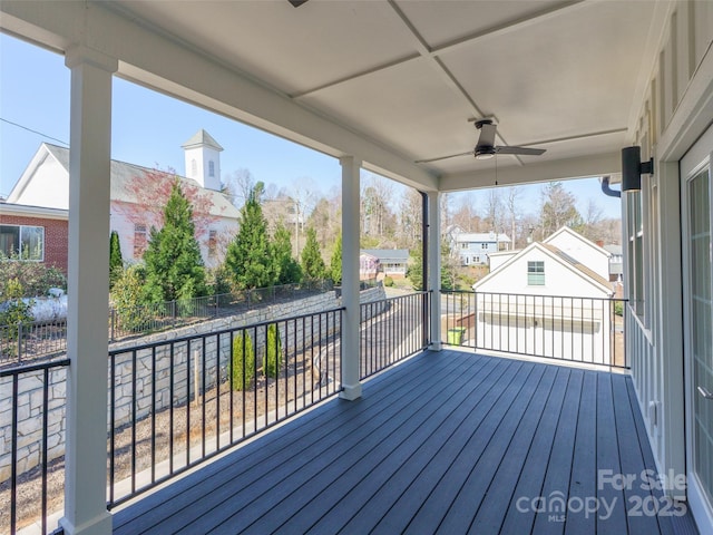 deck featuring a ceiling fan and fence