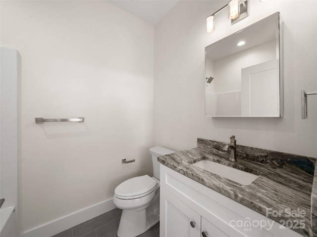 bathroom with baseboards, toilet, tile patterned flooring, and vanity