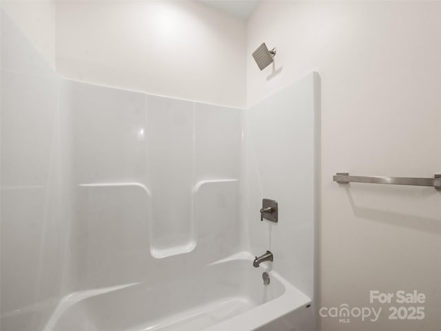 bathroom with bathing tub / shower combination