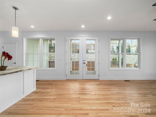 doorway to outside with french doors, light hardwood / wood-style flooring, and ceiling fan