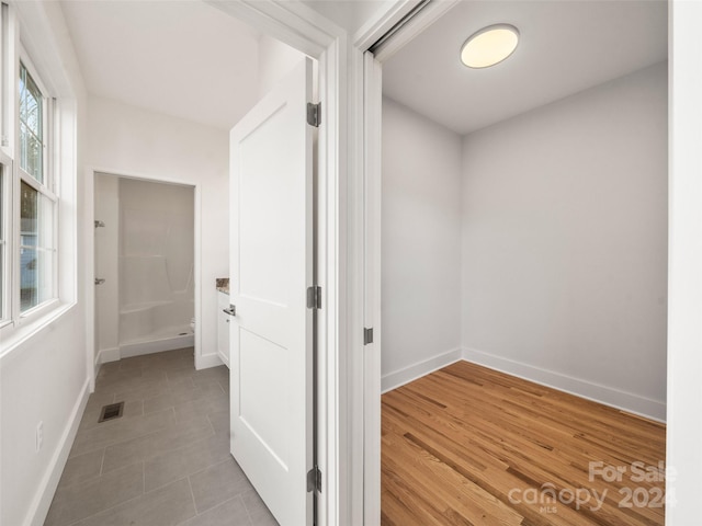 hallway with light hardwood / wood-style floors