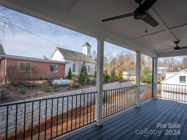 wooden terrace featuring ceiling fan