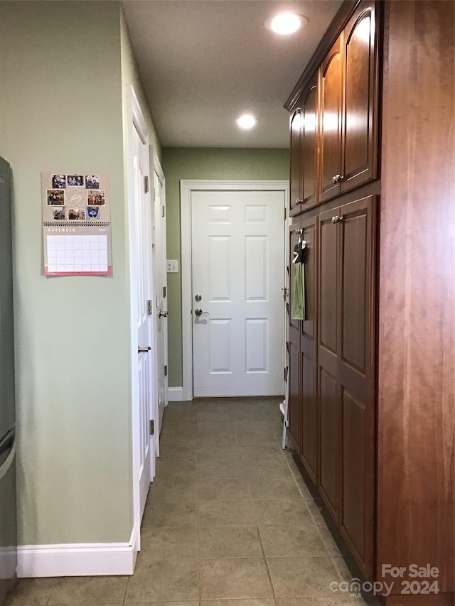 hallway with tile patterned flooring