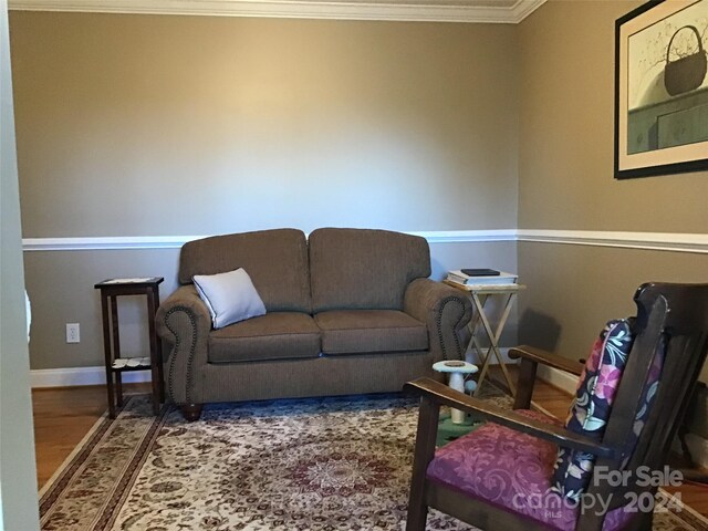 living room featuring crown molding and hardwood / wood-style flooring