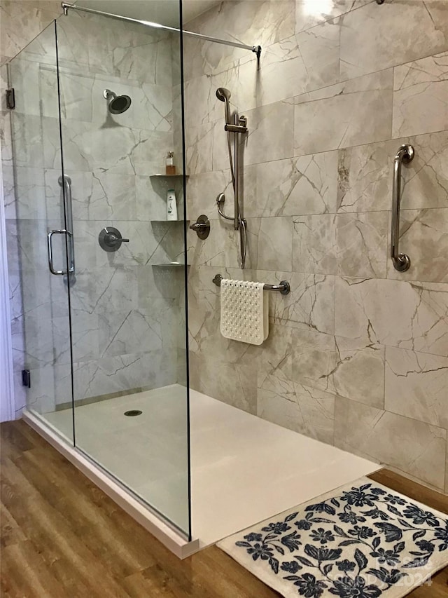 bathroom featuring wood-type flooring and a shower with shower door