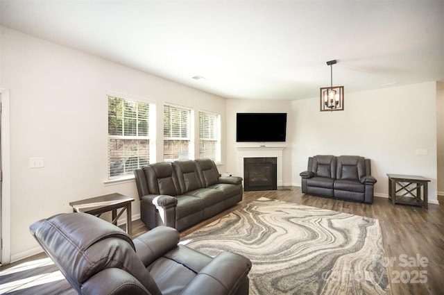 living room featuring wood-type flooring and a chandelier