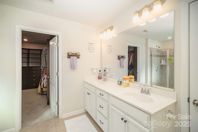 bathroom featuring tile patterned flooring, vanity, and an enclosed shower