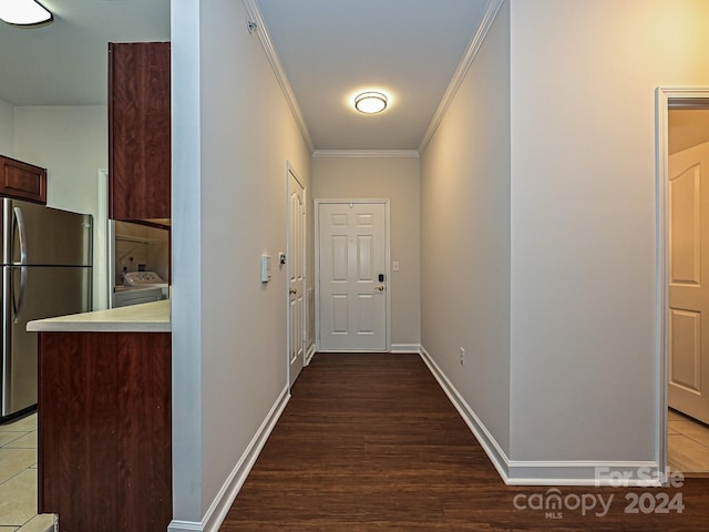 hall featuring dark wood-type flooring and crown molding