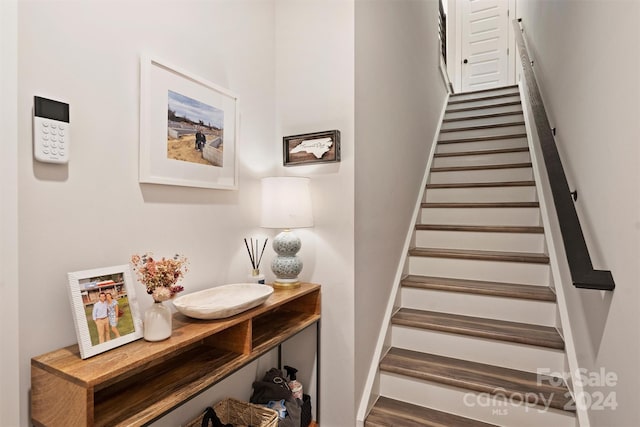 staircase with wood-type flooring