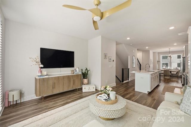 living room with dark hardwood / wood-style floors, sink, and ceiling fan