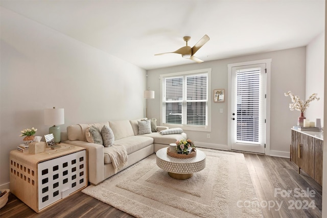 living room with ceiling fan and dark hardwood / wood-style flooring