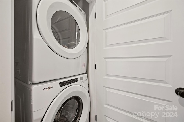 washroom featuring stacked washer / drying machine