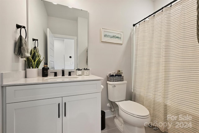 bathroom featuring tile patterned flooring, vanity, and toilet