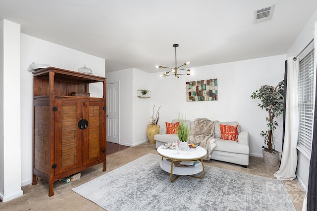 living room featuring light colored carpet and a notable chandelier