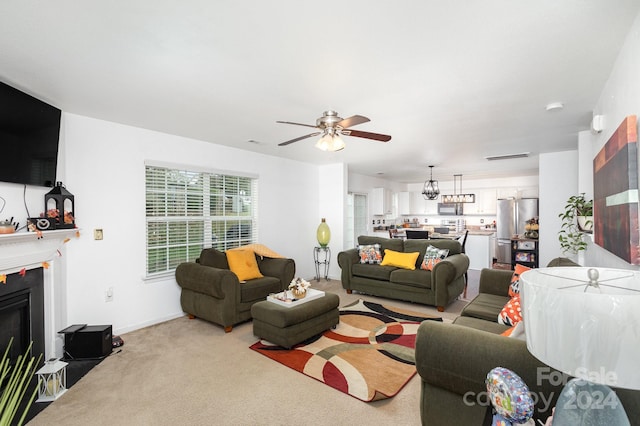 carpeted living room featuring ceiling fan