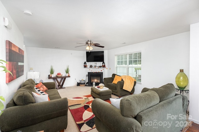 carpeted living room with ceiling fan