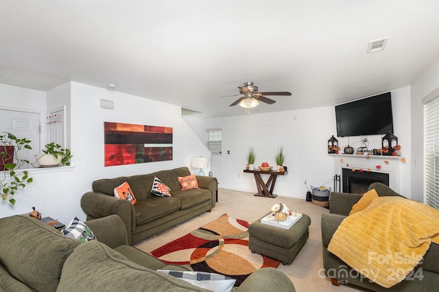 carpeted living room featuring ceiling fan