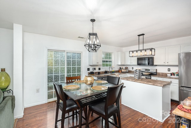 dining space with dark hardwood / wood-style flooring and sink