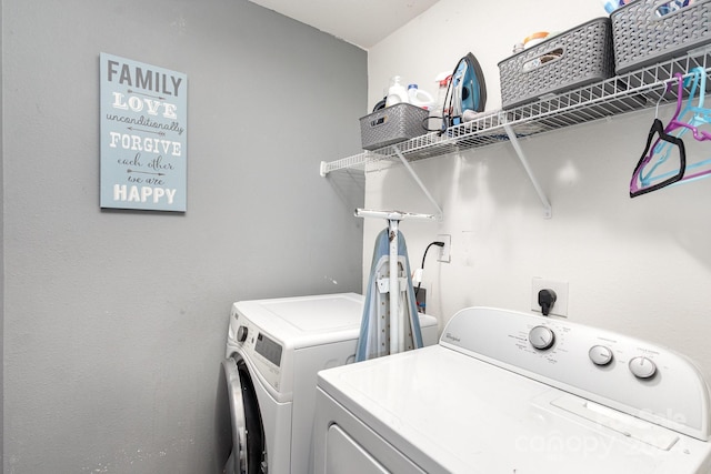 clothes washing area with washer and dryer