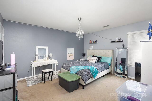 bedroom with a chandelier and carpet