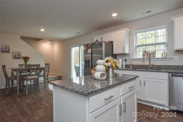 kitchen with white cabinetry, dark hardwood / wood-style flooring, dishwasher, and sink