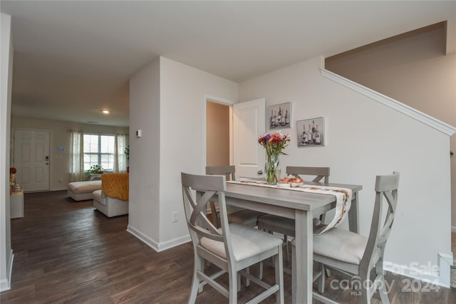 dining area featuring dark wood-type flooring