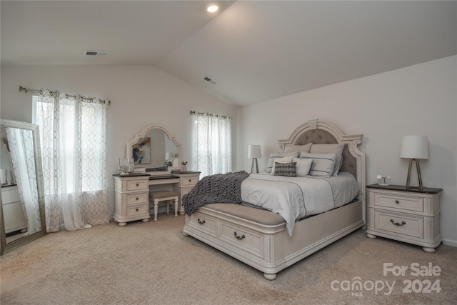 carpeted bedroom featuring multiple windows and lofted ceiling